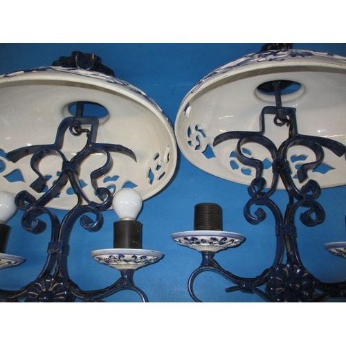 132 - A pair of continental ceramic and iron ceiling lights, blud glaze decoration and twin branch, both i... 