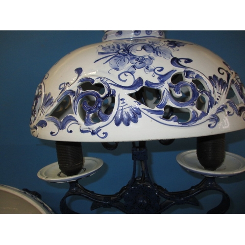 132 - A pair of continental ceramic and iron ceiling lights, blud glaze decoration and twin branch, both i... 