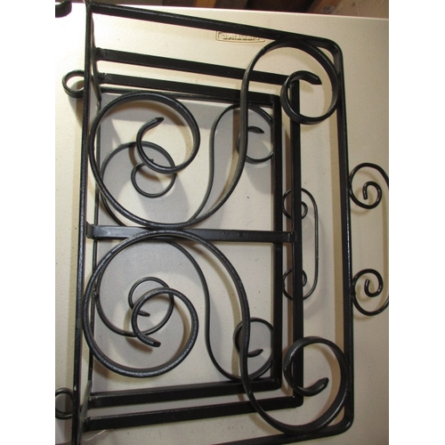 220 - A wrought iron fire screen, magazine rack and coat hook. In useable pre-owned condition