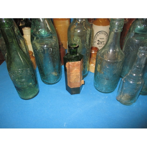 228 - A collection of antique and later glass and stoneware bottles, various makers, some local, all in us... 