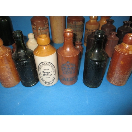 228 - A collection of antique and later glass and stoneware bottles, various makers, some local, all in us... 