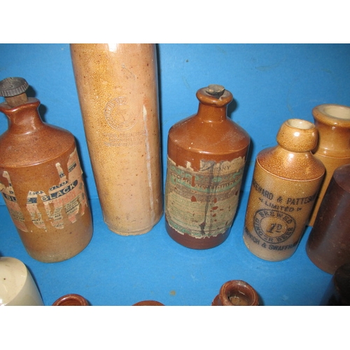 228 - A collection of antique and later glass and stoneware bottles, various makers, some local, all in us... 