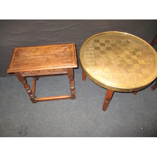 243 - A vintage brass top chess table and an oak joint stool, both in useable pre-owned condition