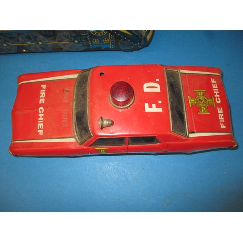 248 - A vintage Japanese tin plate fire chief car, being battery operated and a tin plate train, bell miss... 