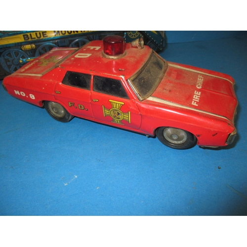 248 - A vintage Japanese tin plate fire chief car, being battery operated and a tin plate train, bell miss... 