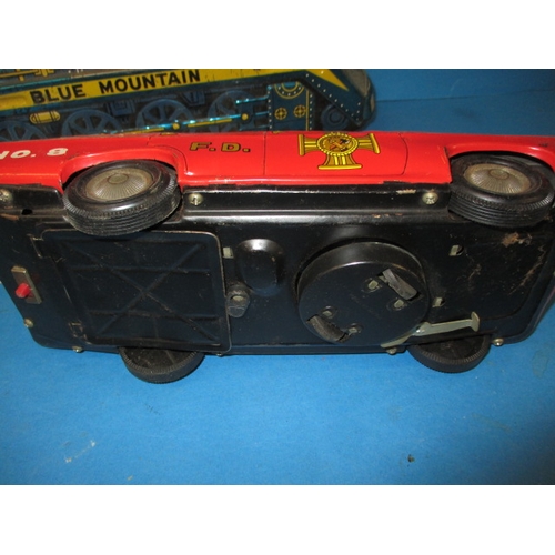 248 - A vintage Japanese tin plate fire chief car, being battery operated and a tin plate train, bell miss... 