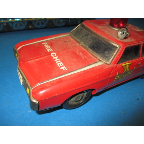 248 - A vintage Japanese tin plate fire chief car, being battery operated and a tin plate train, bell miss... 