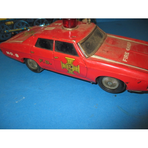 248 - A vintage Japanese tin plate fire chief car, being battery operated and a tin plate train, bell miss... 