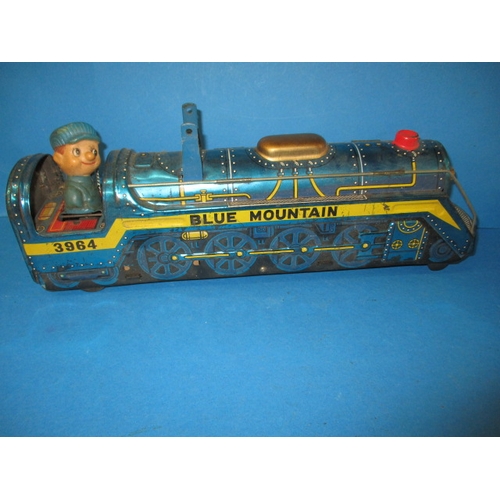 248 - A vintage Japanese tin plate fire chief car, being battery operated and a tin plate train, bell miss... 