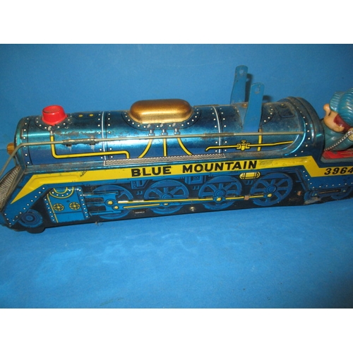 248 - A vintage Japanese tin plate fire chief car, being battery operated and a tin plate train, bell miss... 