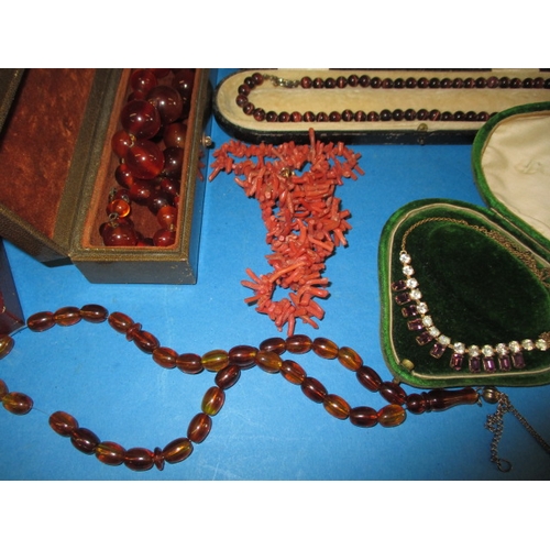 133 - A quantity of vintage necklaces, to include pearl examples with gold clasps, coral and amber, all in... 