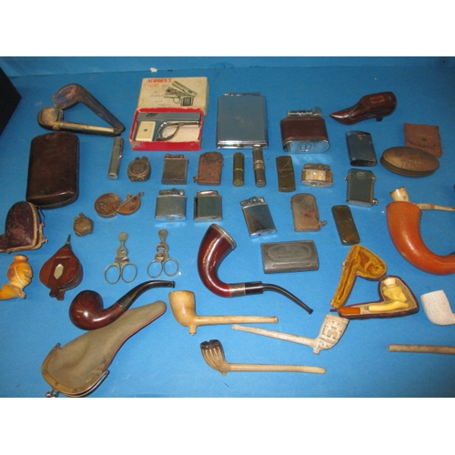 331 - A quantity of vintage smoking related items, to include snuff boxes, pipes and lighters, all in used... 