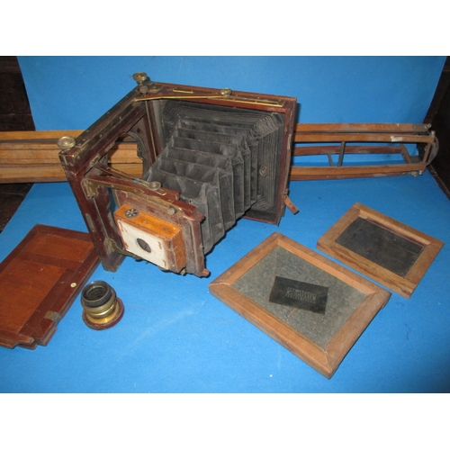 334 - An antique mahogany and brass plate camera and associated tripod, not sure if complete and with use-... 