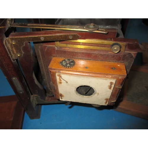 334 - An antique mahogany and brass plate camera and associated tripod, not sure if complete and with use-... 