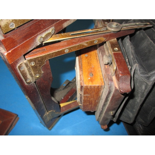 334 - An antique mahogany and brass plate camera and associated tripod, not sure if complete and with use-... 