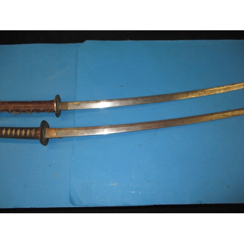 Two vintage Japanese Katana swords, both with use-related marks and probably dating WWII period