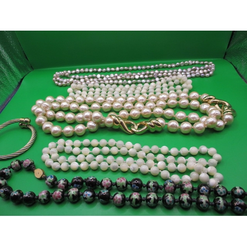 135 - A parcel of costume jewellery necklaces and a sprung metal bangle, all in useable pre-owned conditio... 