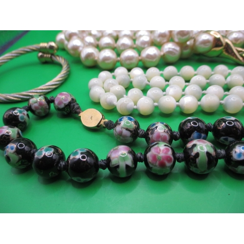 135 - A parcel of costume jewellery necklaces and a sprung metal bangle, all in useable pre-owned conditio... 