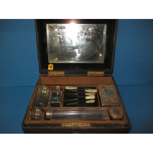 153 - A late 19th century valet box with contents of silver top jars, Birmingham hallmark, in well used co... 