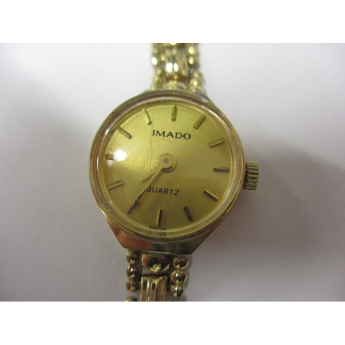 101 - A 1991 IMADO 9ct gold watch and strap, with original box and papers and in good working order, appro... 