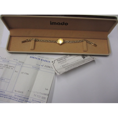 101 - A 1991 IMADO 9ct gold watch and strap, with original box and papers and in good working order, appro... 