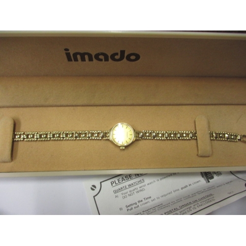 101 - A 1991 IMADO 9ct gold watch and strap, with original box and papers and in good working order, appro... 