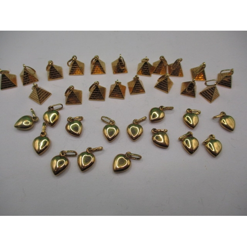 64 - A parcel of 9ct gold charms, pyramid and heart shaped, approx. parcel weight 19.7, all in unused con... 