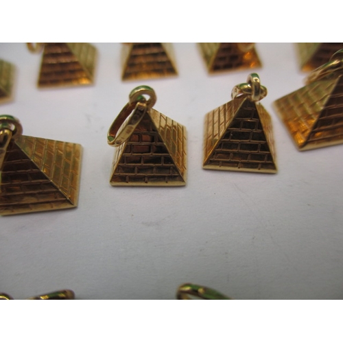 64 - A parcel of 9ct gold charms, pyramid and heart shaped, approx. parcel weight 19.7, all in unused con... 