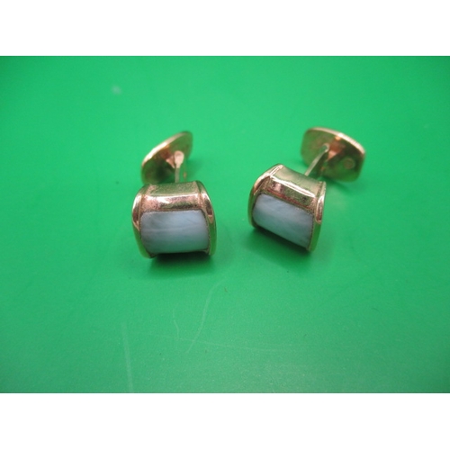 76 - A pair of 750 yellow gold cufflinks set with pale green hard stone panels, approx. gross weight 8.6g... 