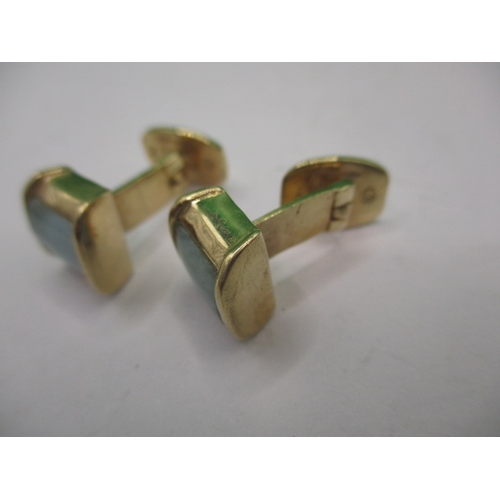 76 - A pair of 750 yellow gold cufflinks set with pale green hard stone panels, approx. gross weight 8.6g... 