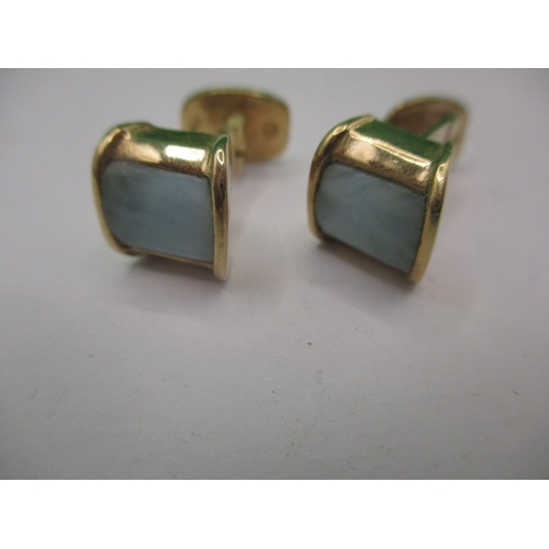 76 - A pair of 750 yellow gold cufflinks set with pale green hard stone panels, approx. gross weight 8.6g... 