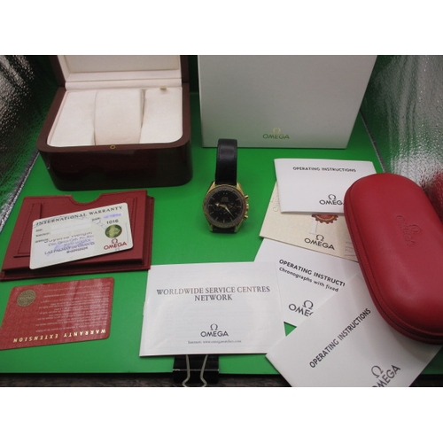 104 - An 18ct gold cased Omega Speedmaster automatic chronometer watch, with box and paperwork, dated 2002...