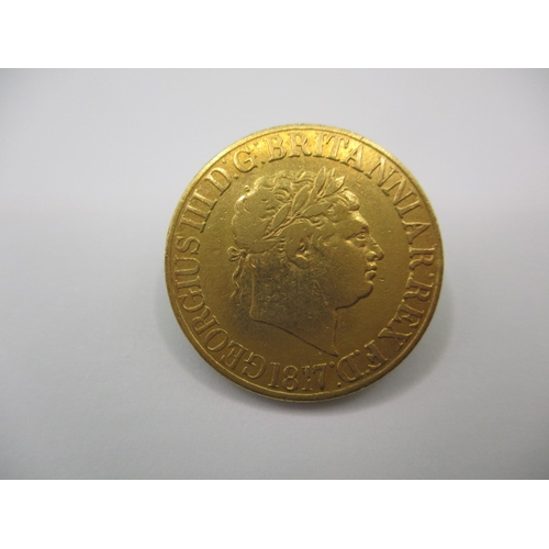 226 - A George III  gold sovereign dated 1817, a fine grade coin that’s previously been in a fob mount