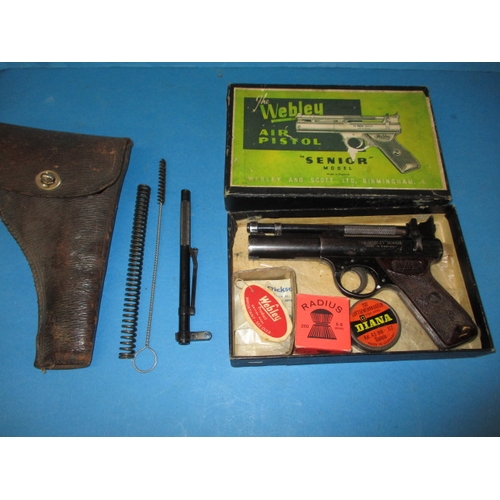 319 - A late 1950s Webley senior air pistol, in box with .177 and .22 barrels and other accessories and a ... 