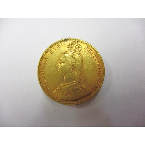 A Victorian gold sovereign dated 1887, a circulated coin with fine definition of features