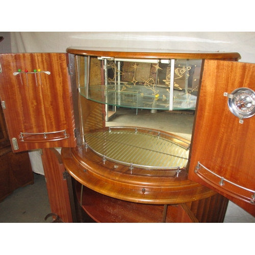 349 - A mid 20th century art deco drinks cabinet by Rivington, having walnut veneer,  mirrored interior, i... 