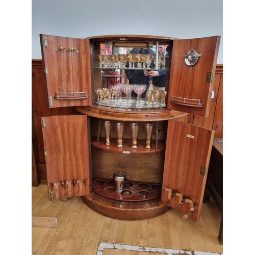 349 - A mid 20th century art deco drinks cabinet by Rivington, having walnut veneer,  mirrored interior, i... 