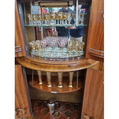 349 - A mid 20th century art deco drinks cabinet by Rivington, having walnut veneer,  mirrored interior, i... 