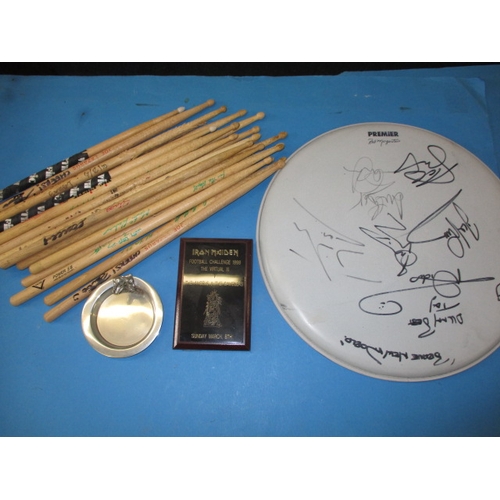 10 - A parcel of pop memorabilia from the group Iron Maiden, to include drum sticks and a drum top skin w... 