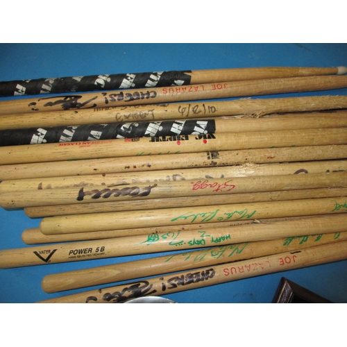 10 - A parcel of pop memorabilia from the group Iron Maiden, to include drum sticks and a drum top skin w... 