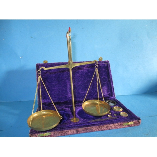 21 - A boxed set of portable balance scales, in fitted case with complete set of weights, previous proper... 