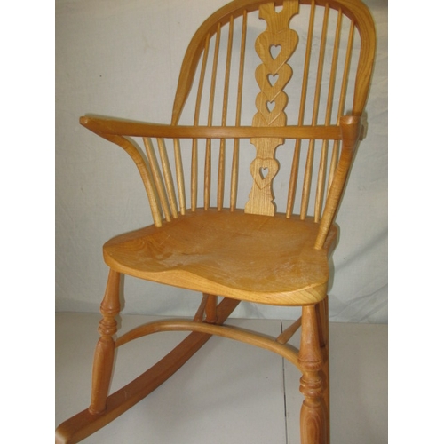 65 - A hardwood rocking chair, makers mark for C J Marsterson in good pre-owned condition