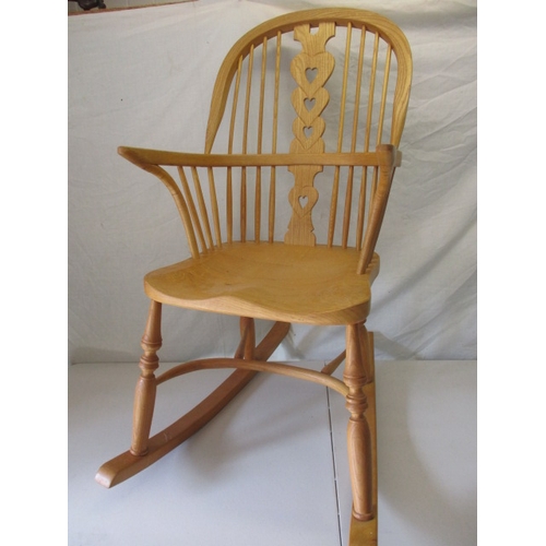 65 - A hardwood rocking chair, makers mark for C J Marsterson in good pre-owned condition