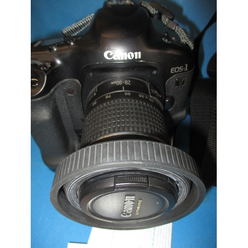 75 - A Canon EOS1 camera, with kit bag, paperwork and a lens, in used condition and not tested as to func... 