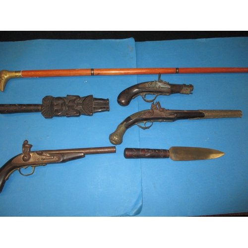 77 - A quantity of wall hanging weapons and a walking stick, some damages