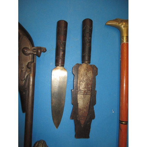 77 - A quantity of wall hanging weapons and a walking stick, some damages