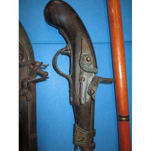 77 - A quantity of wall hanging weapons and a walking stick, some damages