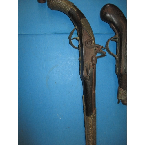 77 - A quantity of wall hanging weapons and a walking stick, some damages