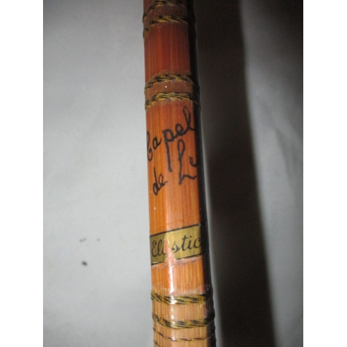 111 - A vintage fly fishing cane rod and 4 reels. Rod by ‘Capella de Luxe’. In used condition with age rel... 