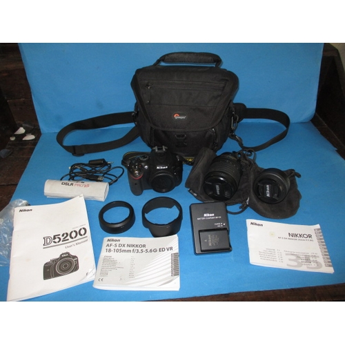 113 - A pre-owned Nikon D5200 camera with 2 lenses, in current working order with charger, leads and kit b... 